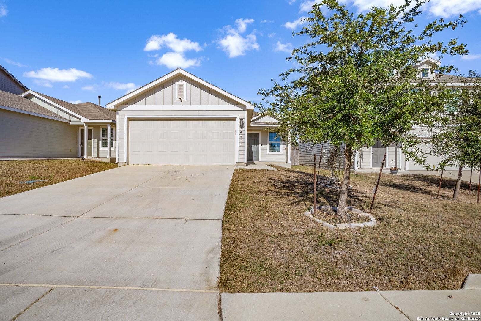 a view of a house with a yard and garage