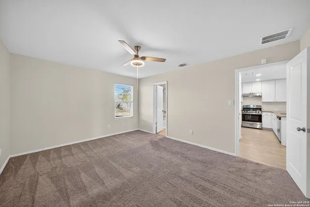 a view of a kitchen with a sink and a refrigerator