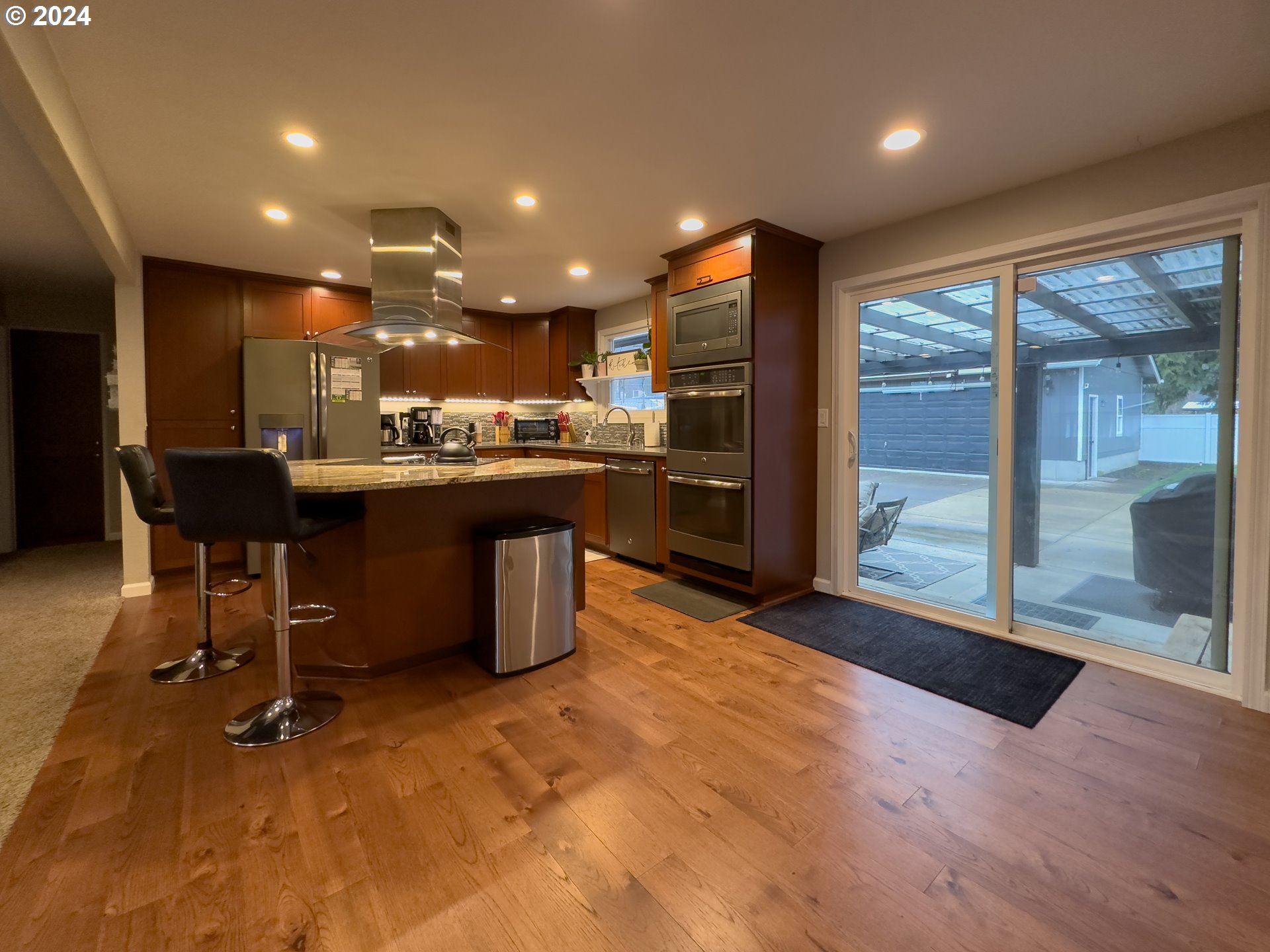 6875 A Street Springfield, OR 97478 - Photo 8 of 48 a open kitchen with stainless steel appliances granite countertop a refrigerator a sink a dining table and chairs