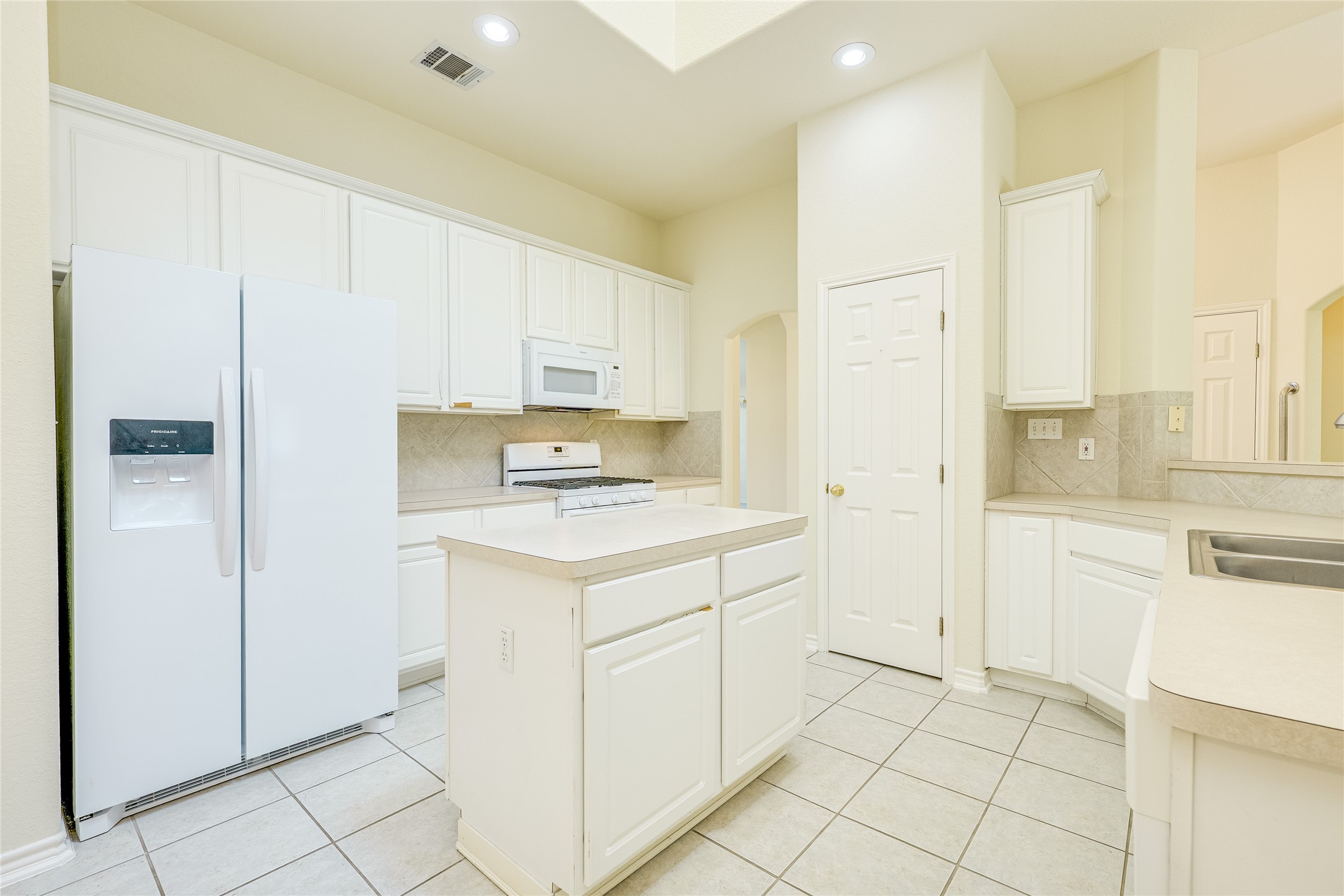 111 Arrowhead Lane Georgetown, TX 78628 - Photo 17 of 40 a kitchen with white cabinets and white appliances