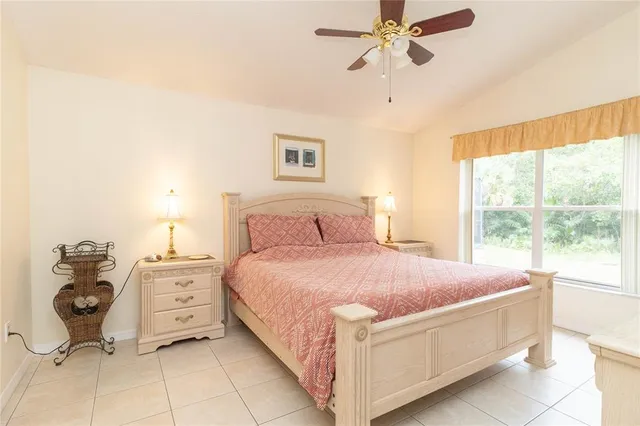 a bedroom with a bed and window