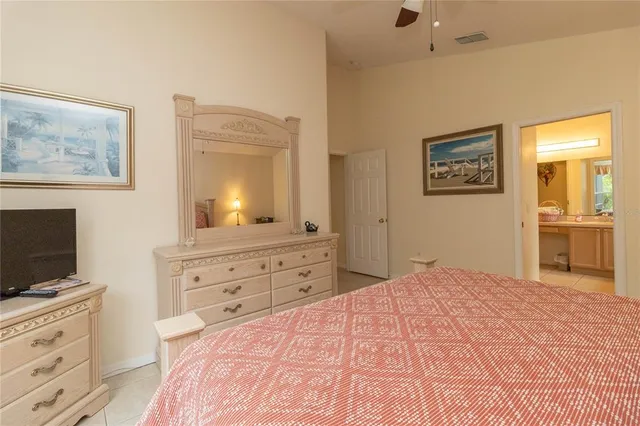 a bedroom with a bed and a flat screen tv in it