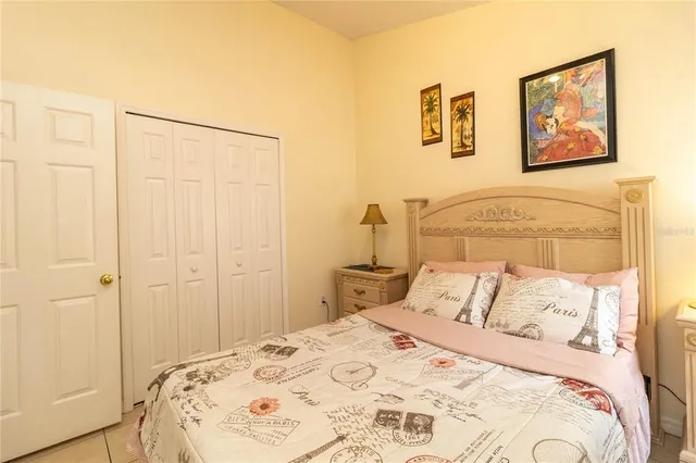 a bedroom with a bed and a painting on the wall