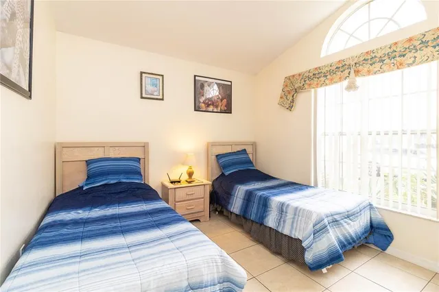 a bedroom with two beds and a window