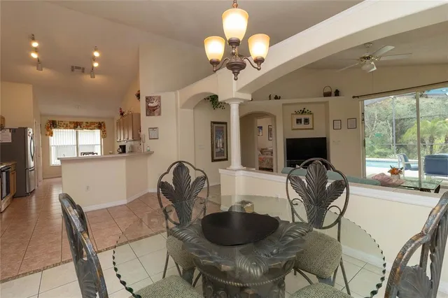 a view of a dining room with furniture and a large window