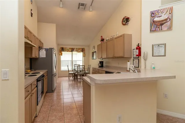 a kitchen with sink cabinets and living room