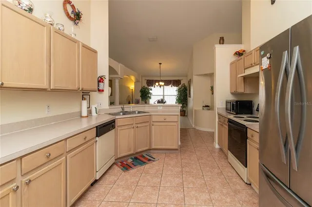 a kitchen with a sink cabinets and stainless steel appliances