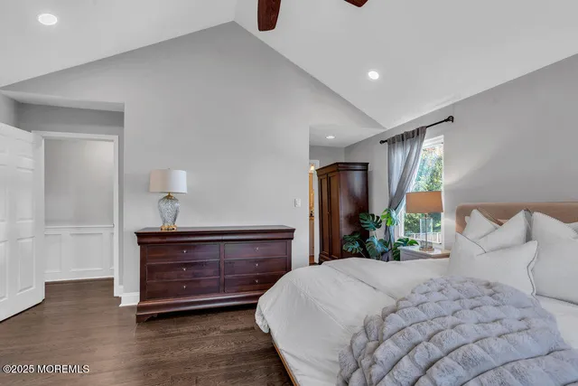 a bedroom with a large bed and a window