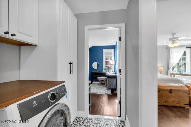 a view of a patio with table and chairs potted plants and large tree