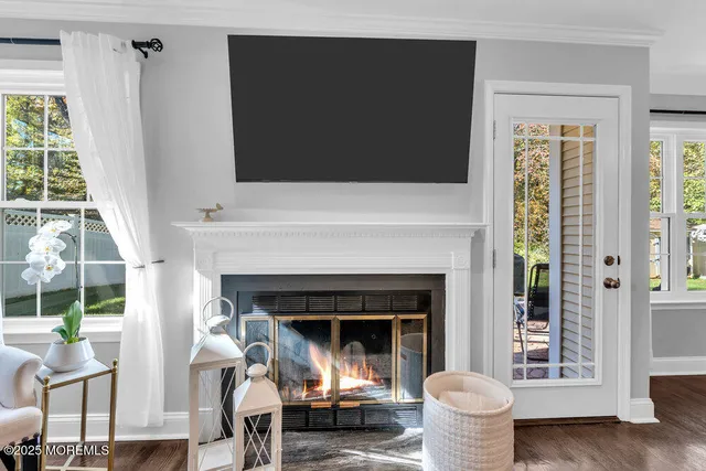 a living room with a fireplace and a large window