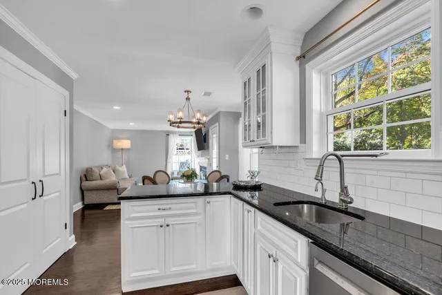 a kitchen with stainless steel appliances a stove a sink a stove microwave and cabinets