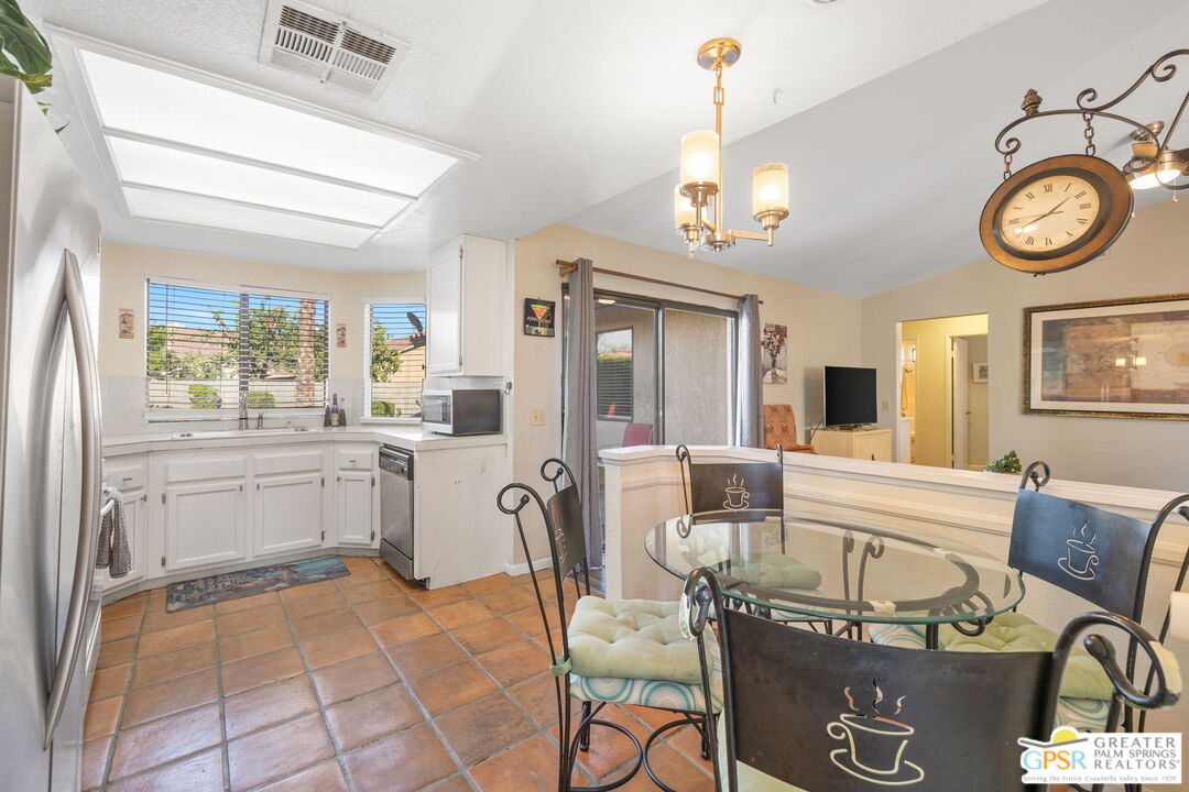 45688 Sutter Creek Road Indio, CA 92201 - Photo 15 of 51 a very nice looking dining room with a large window and stainless steel appliances