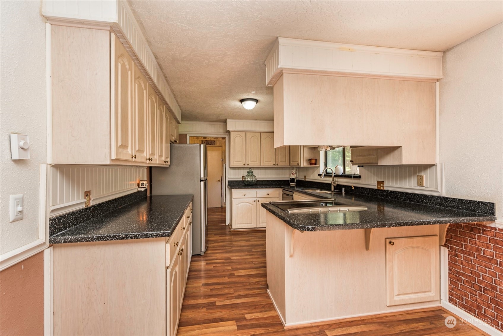 306 Webb Road Sequim, WA 98382 - Photo 12 of 40 a kitchen with granite countertop a sink a counter top space and cabinets
