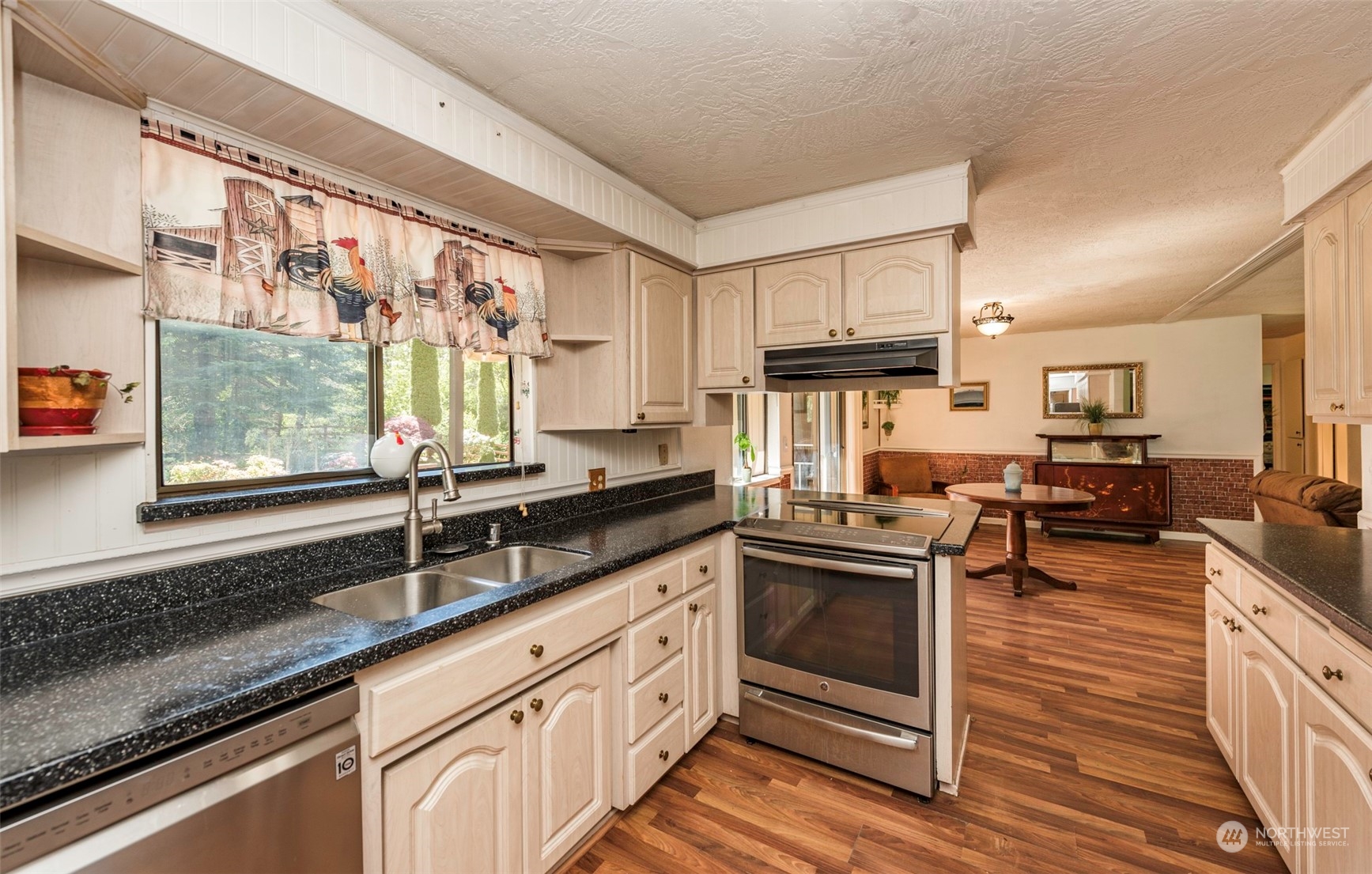 306 Webb Road Sequim, WA 98382 - Photo 13 of 40 a kitchen with stainless steel appliances granite countertop a sink stove and cabinets