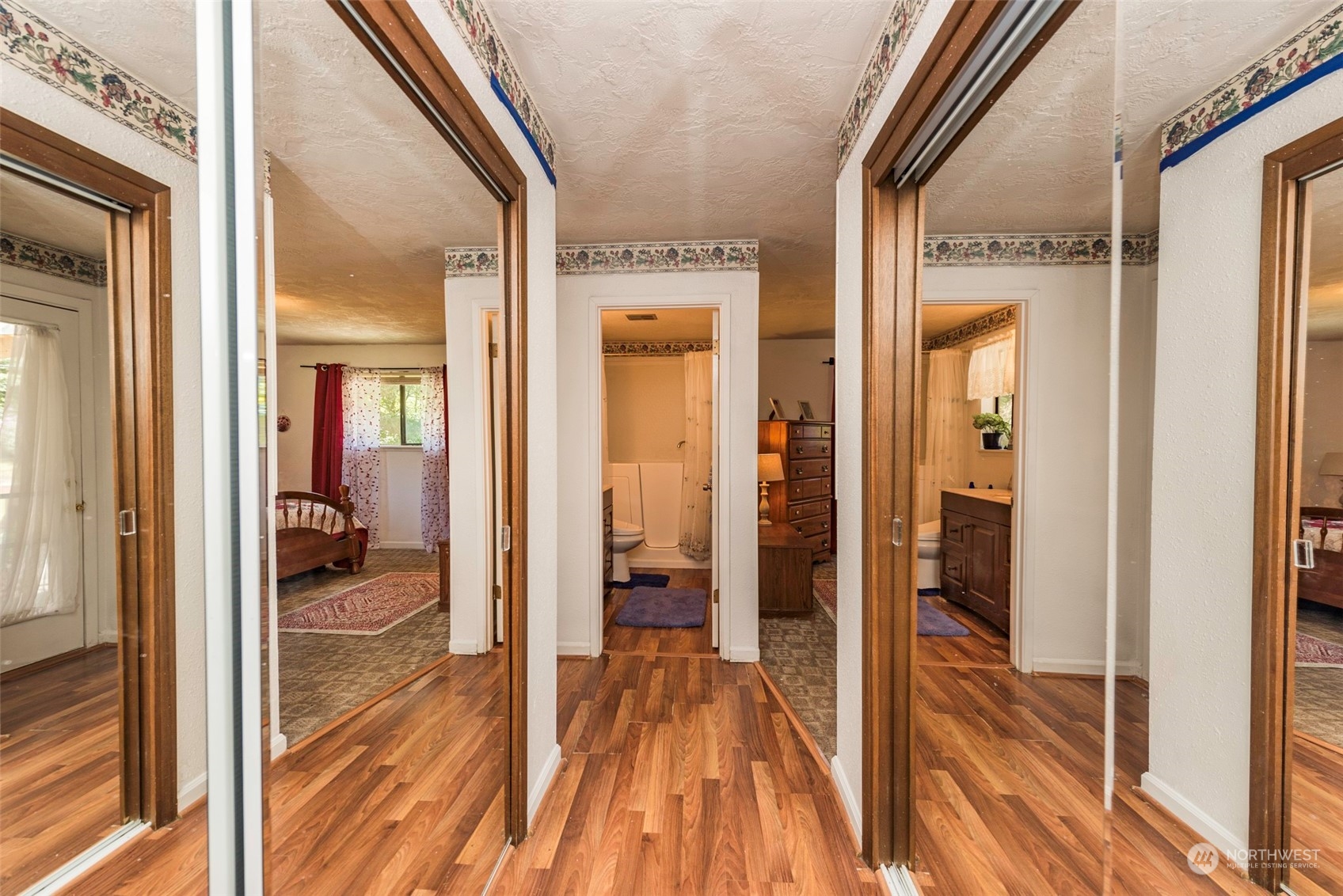 306 Webb Road Sequim, WA 98382 - Photo 20 of 40 a view of a hallway with wooden floor windows and a livingroom