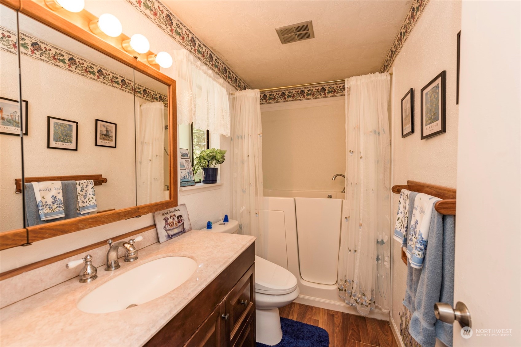306 Webb Road Sequim, WA 98382 - Photo 21 of 40 a bathroom with a sink a toilet a mirror and shower