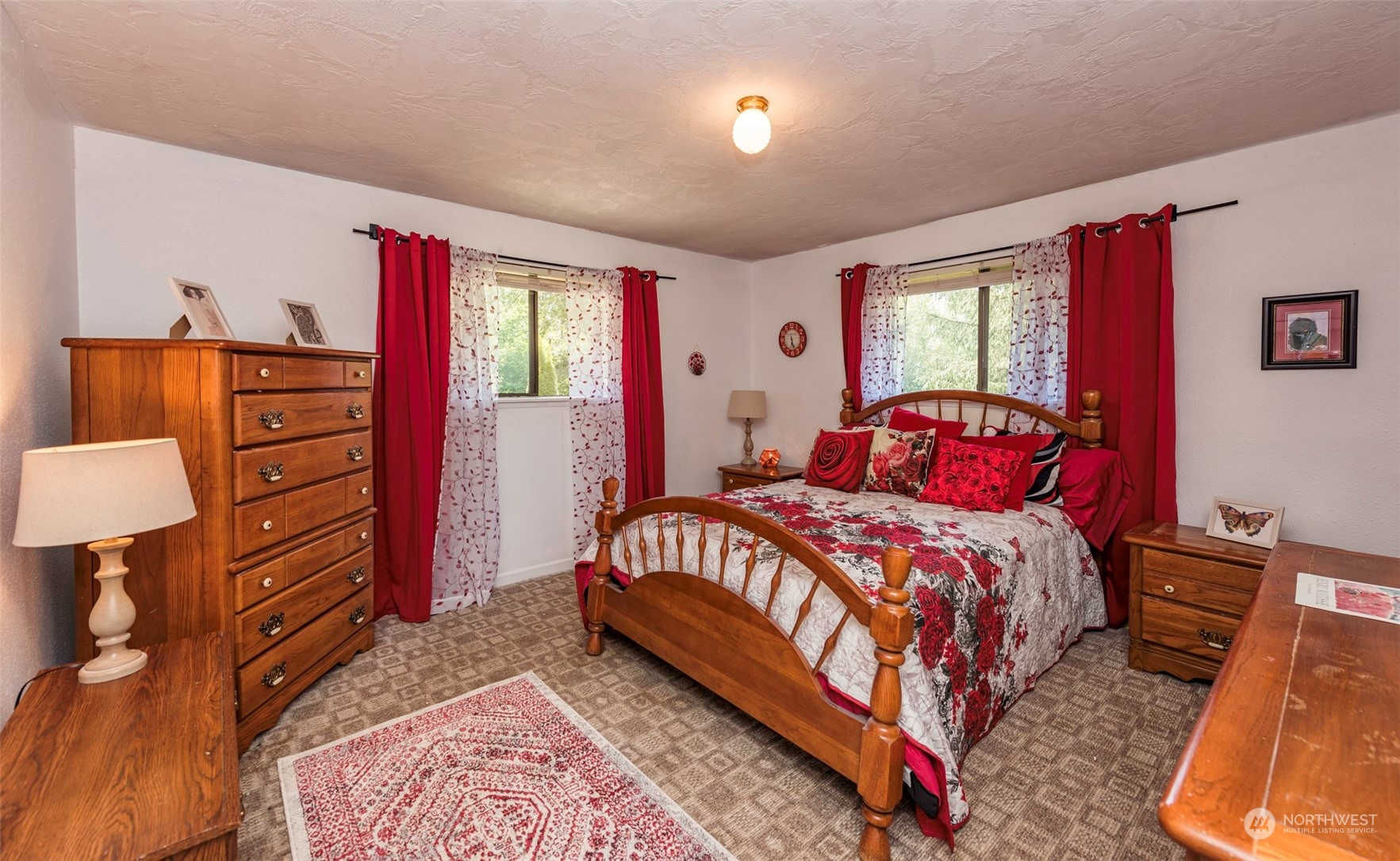 306 Webb Road Sequim, WA 98382 - Photo 22 of 40 a bedroom with a bed and a dresser
