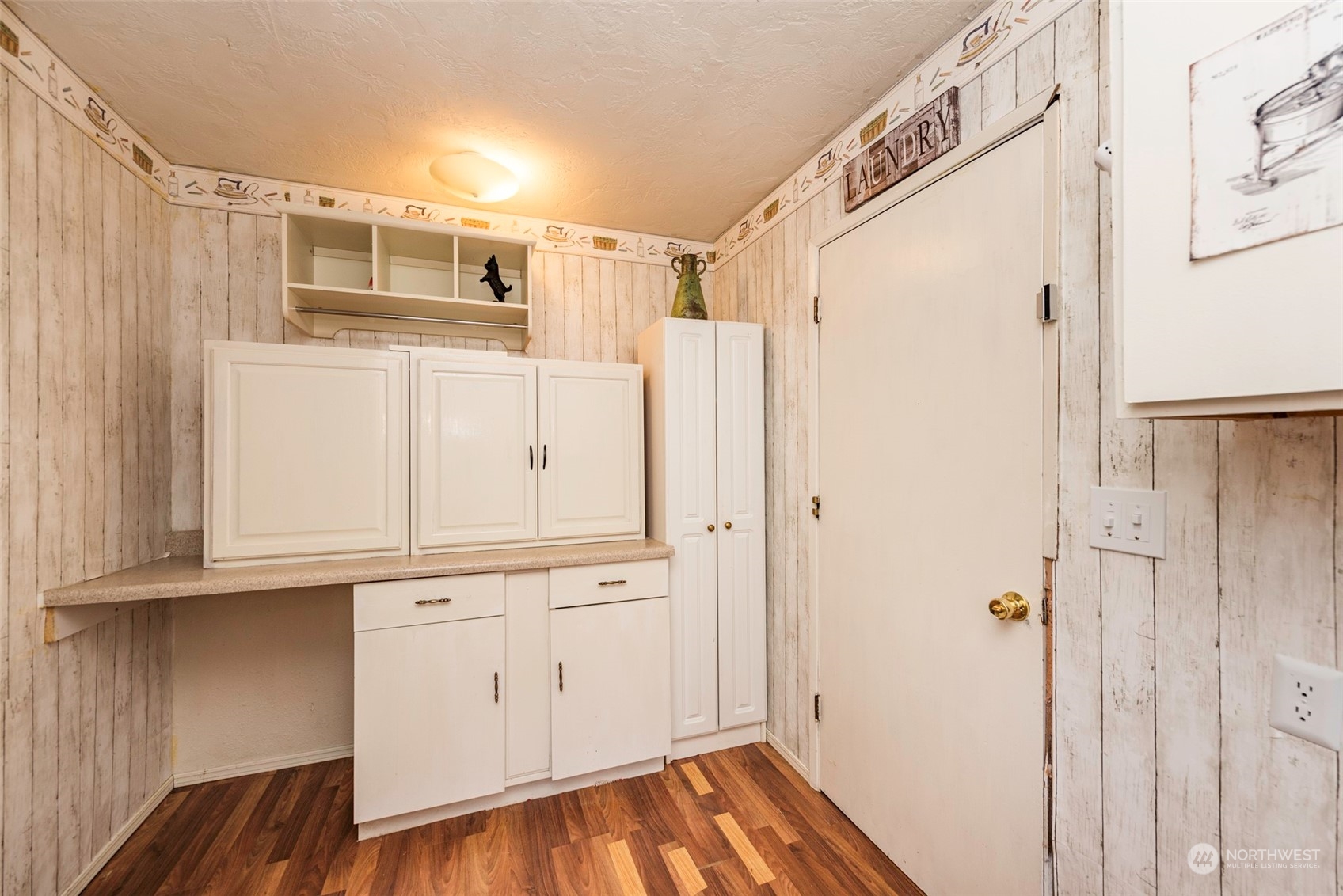 306 Webb Road Sequim, WA 98382 - Photo 25 of 40 a view of a kitchen with white cabinets and wooden floor