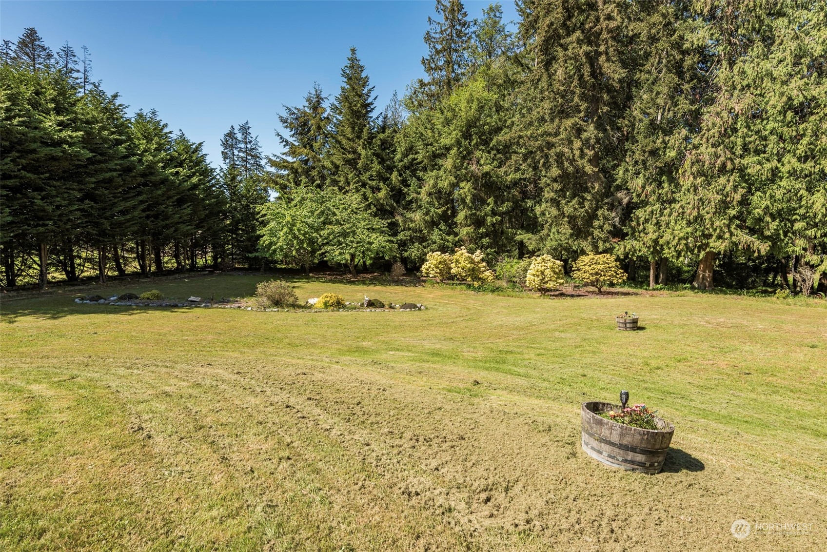 306 Webb Road Sequim, WA 98382 - Photo 3 of 40 a backyard of a house with lots of green space