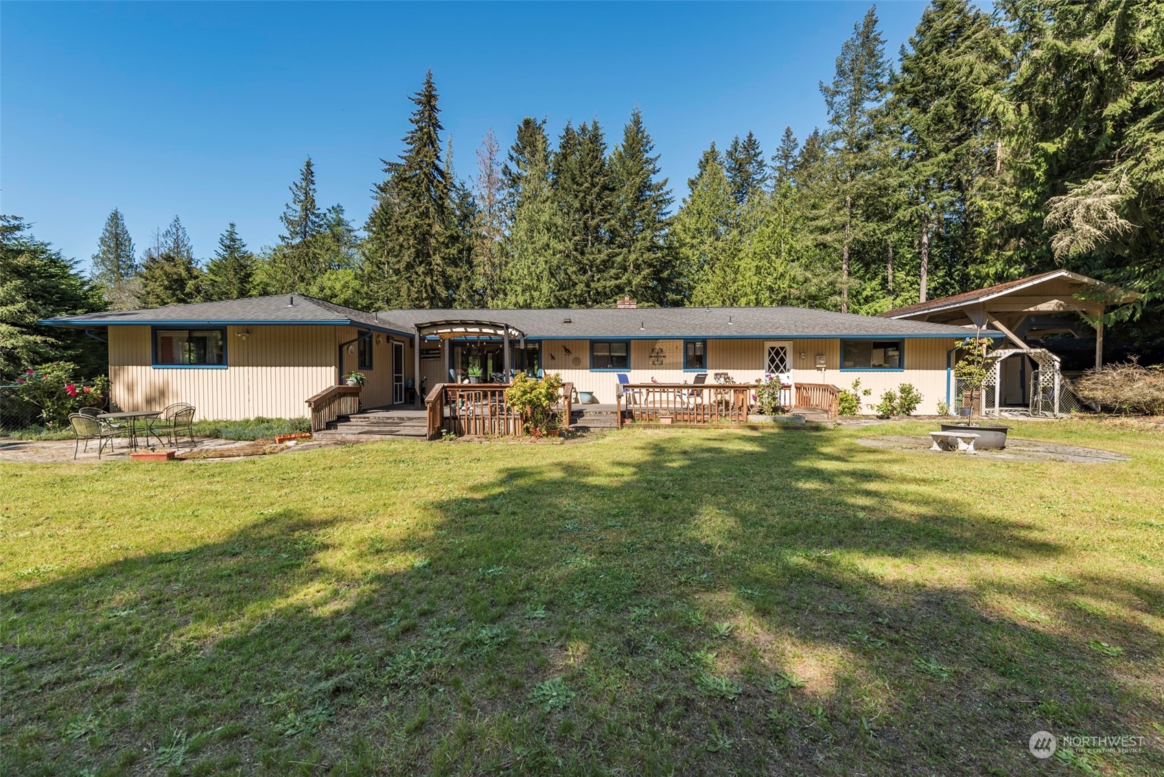 306 Webb Road Sequim, WA 98382 - Photo 31 of 40 a front view of a house with swimming pool having outdoor seating
