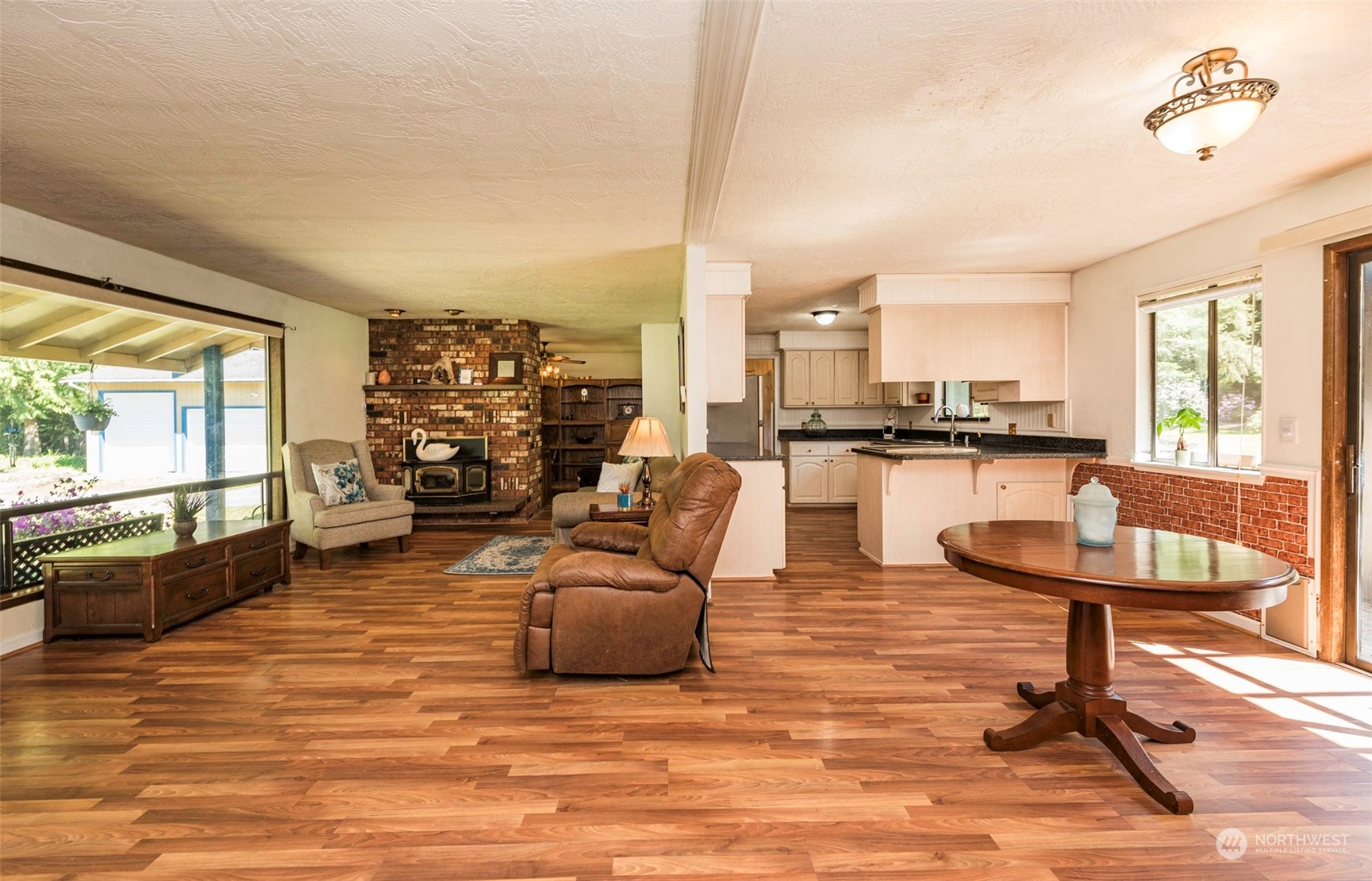 306 Webb Road Sequim, WA 98382 - Photo 5 of 40 a living room with couches chairs and kitchen view with wooden floor