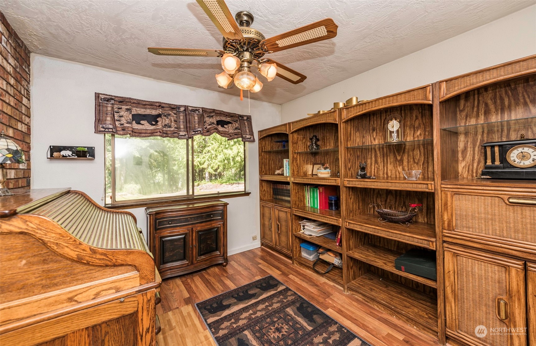 306 Webb Road Sequim, WA 98382 - Photo 8 of 40 a living room with furniture a flat screen tv and a book shelf