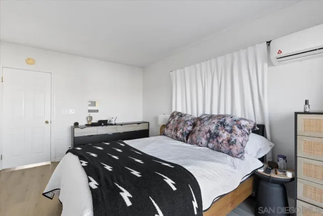 a bedroom with a bed and a potted plant