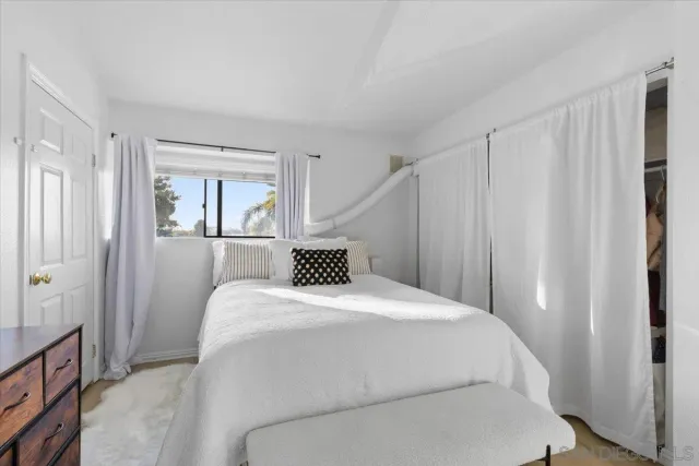 a bedroom with a bed and a mirror