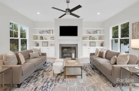 a living room with furniture fireplace and a flat screen tv