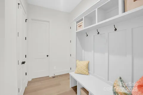 a view of a room with furniture and wooden floor