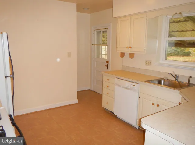 a utility room with cabinets washer and dryer