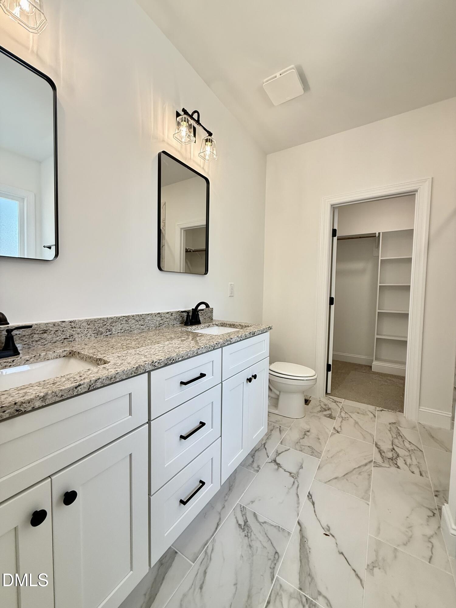 10300 Stallings Road Spring Hope, NC 27882 - Photo 22 of 36 a spacious bathroom with a granite countertop sink and a mirror