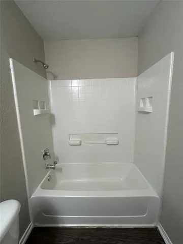 a bathroom with a toilet a sink and a bathtub