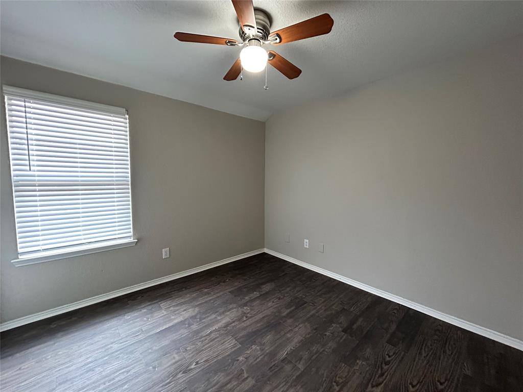 1249 Round Pen Run Fort Worth, TX 76052 - Photo 20 of 28 wooden floor in an empty room with a window