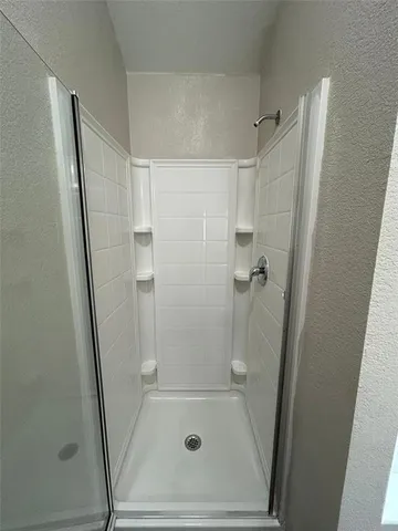 a bathroom with a shower and a sink