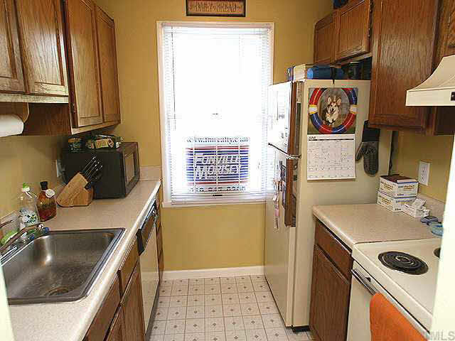 7707 Kingsberry Court Raleigh, NC 27615 - Photo 3 of 9 a bathroom with a sink and a washing machine
