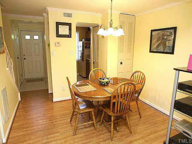 7707 Kingsberry Court Raleigh, NC 27615 - Photo 4 of 9 a view of a dining room with furniture and chandelier