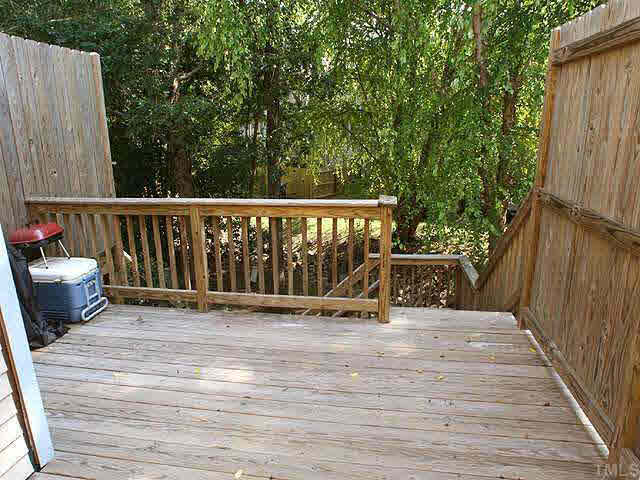 7707 Kingsberry Court Raleigh, NC 27615 - Photo 8 of 9 a view of deck with furniture and trees around