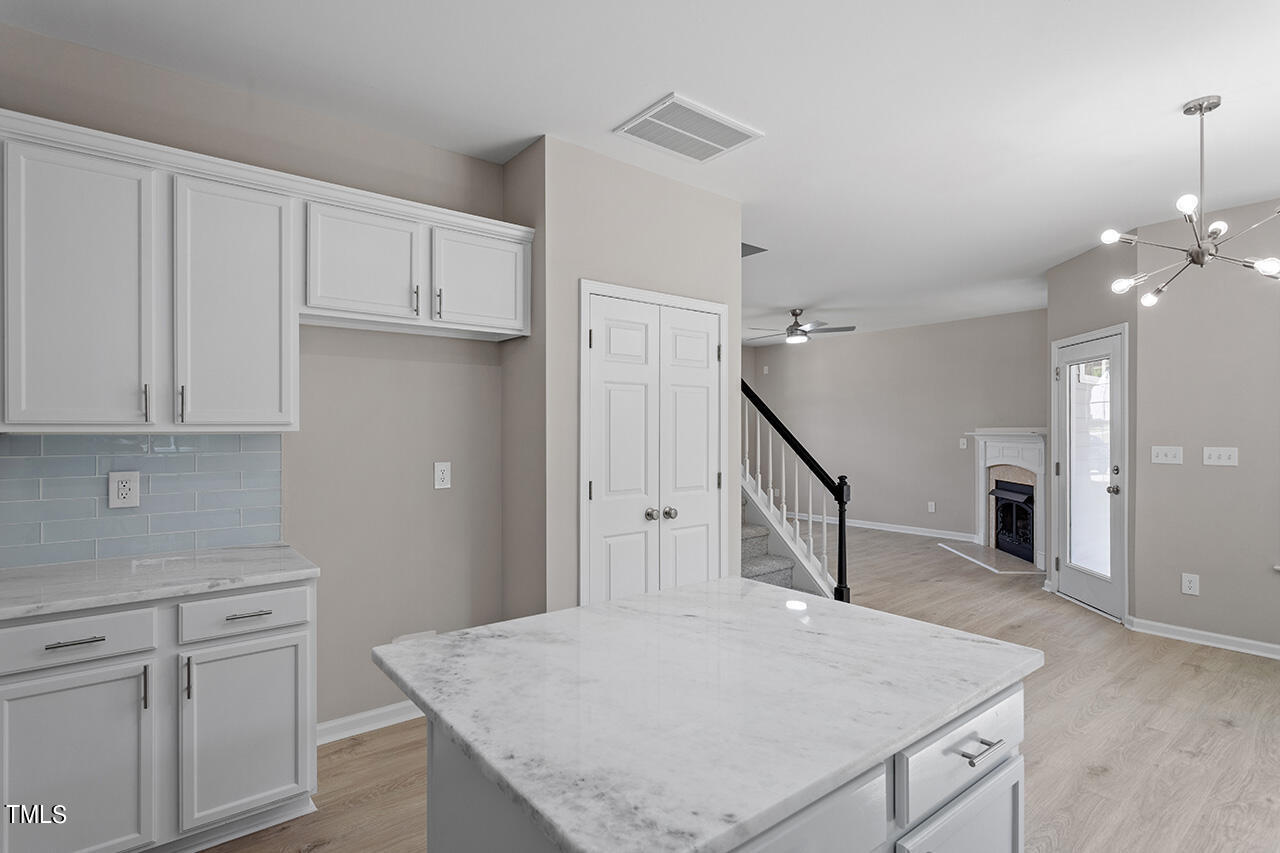 617 McCarthy Drive Clayton, NC 27527 - Photo 12 of 44 a kitchen that has a lot of cabinets in it