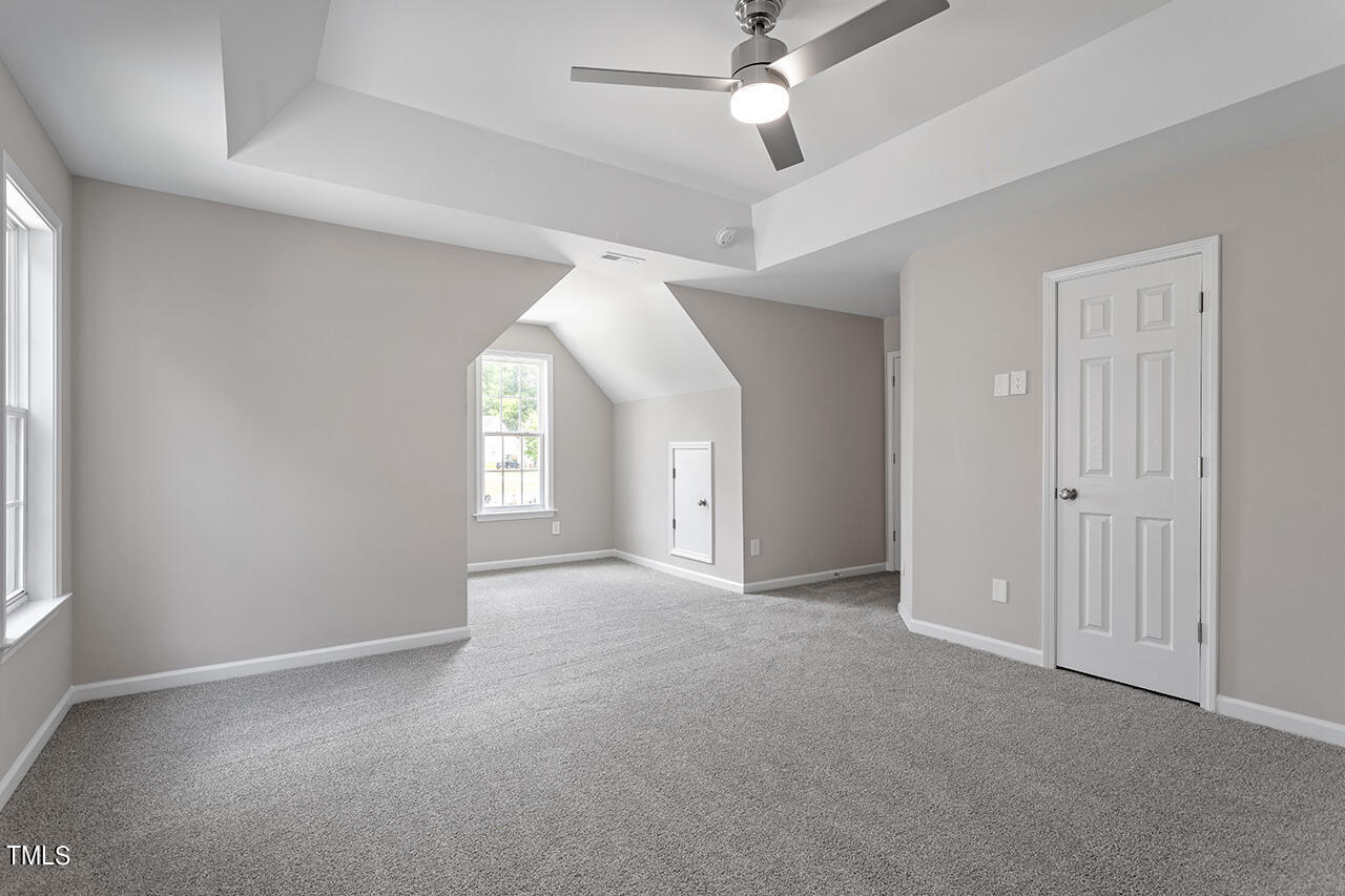 617 McCarthy Drive Clayton, NC 27527 - Photo 17 of 44 an empty room with a ceiling fan and a window