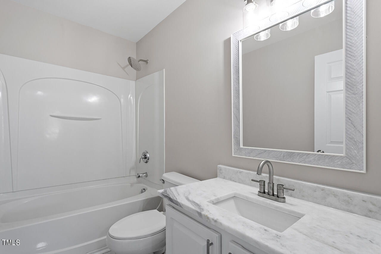 617 McCarthy Drive Clayton, NC 27527 - Photo 23 of 44 a bathroom with a sink a toilet and shower