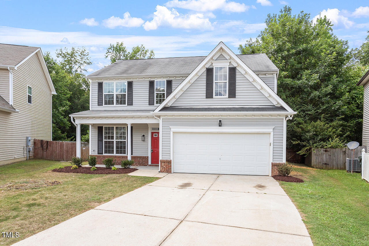 617 McCarthy Drive Clayton, NC 27527 - Photo 25 of 44 a front view of a house with a yard and potted plants