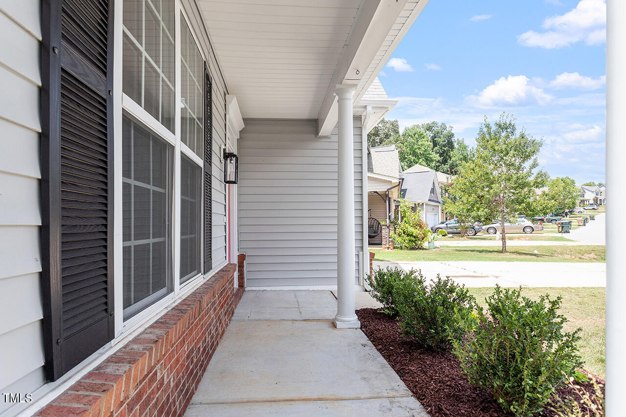 617 McCarthy Drive Clayton, NC 27527 - Photo 28 of 44 a view of a pathway of a house with backyard and floor to ceiling window