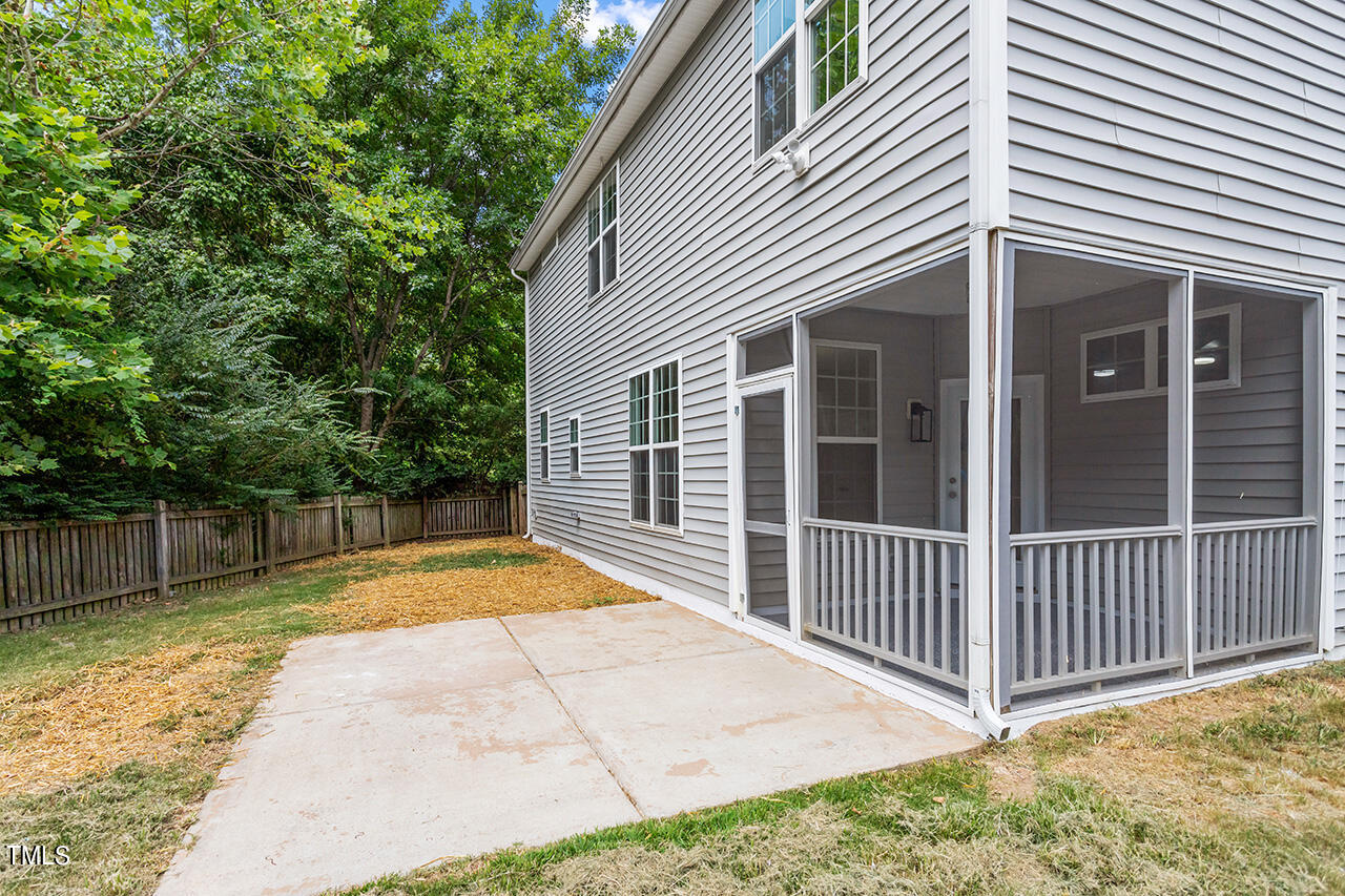 617 McCarthy Drive Clayton, NC 27527 - Photo 30 of 44 a view of backyard with large trees and wooden fence