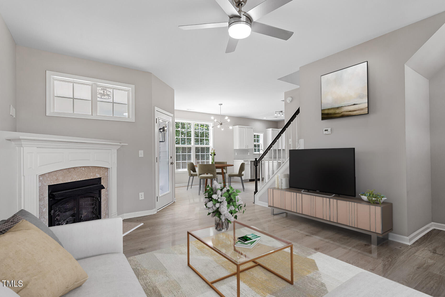 617 McCarthy Drive Clayton, NC 27527 - Photo 4 of 44 a living room with furniture a flat screen tv and a fireplace