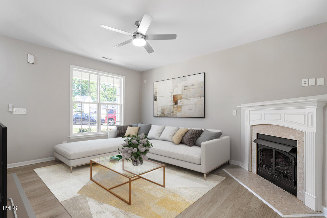 617 McCarthy Drive Clayton, NC 27527 - Photo 5 of 44 a living room with furniture and a fireplace