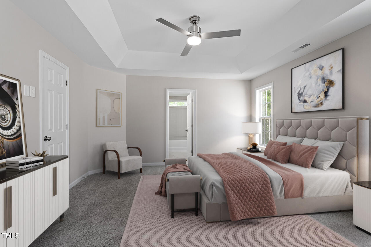 617 McCarthy Drive Clayton, NC 27527 - Photo 7 of 44 a spacious bedroom with a bed and a chandelier