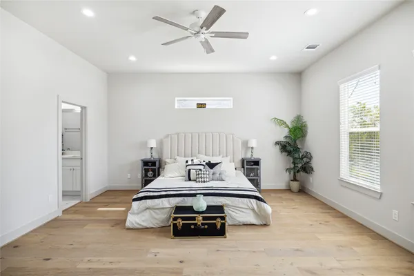 a bedroom with a bed and wooden floor