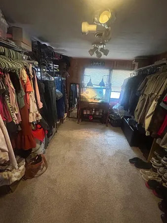 a bedroom with two beds and a lamp