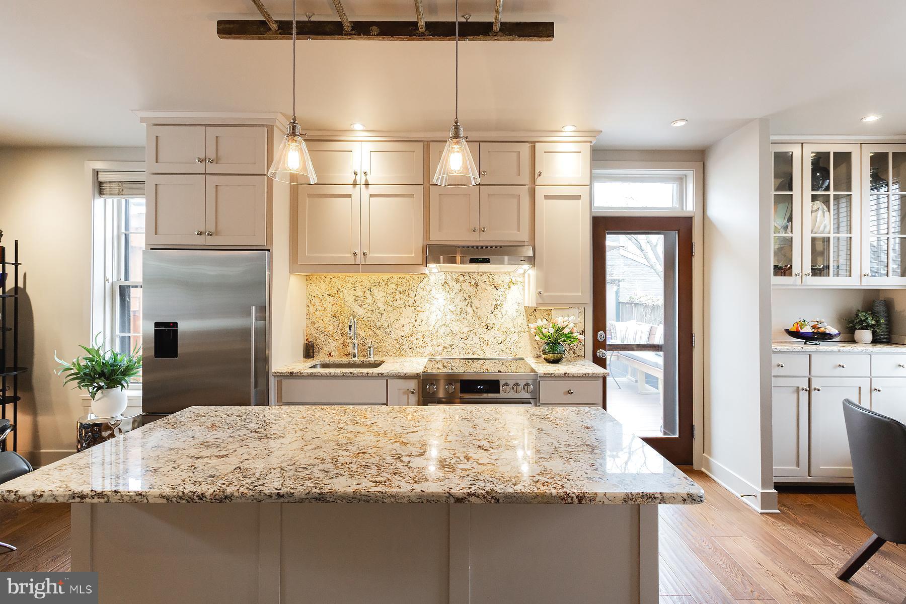 125 South Duke Street Lancaster, PA 17602 - Photo 11 of 40 a kitchen with kitchen island granite countertop a large window cabinets and stainless steel appliances